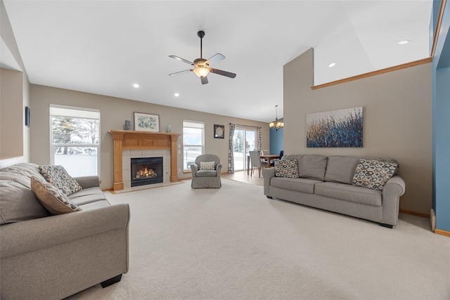 living area featuring high vaulted ceiling, recessed lighting, light colored carpet, a ceiling fan, and a tiled fireplace