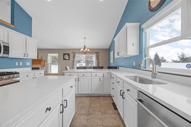 kitchen featuring stainless steel appliances, a sink, and light countertops