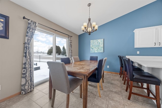 dining space with vaulted ceiling, light tile patterned floors, baseboards, and an inviting chandelier