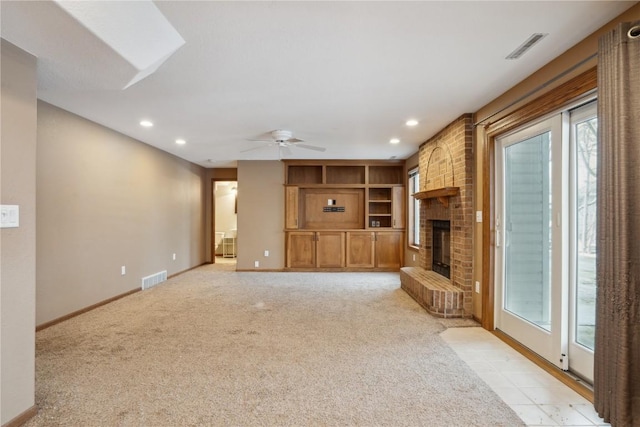 unfurnished living room with recessed lighting, a brick fireplace, visible vents, and baseboards