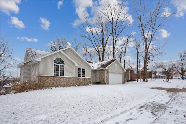 view of front of property with a garage and brick siding