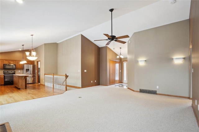 living room with visible vents, light carpet, high vaulted ceiling, baseboards, and ceiling fan with notable chandelier