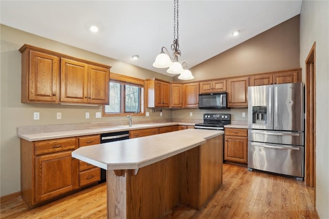 kitchen with lofted ceiling, stainless steel appliances, light wood-type flooring, and light countertops