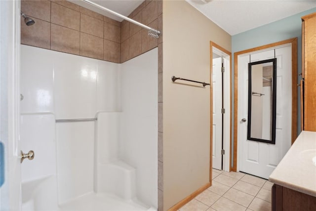 full bathroom featuring a shower, tile patterned flooring, and vanity