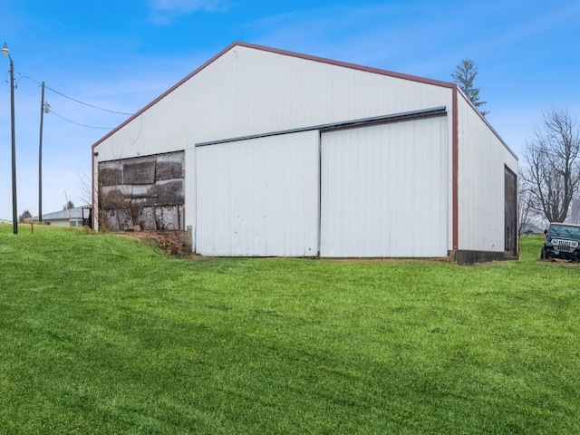 view of pole building with a lawn