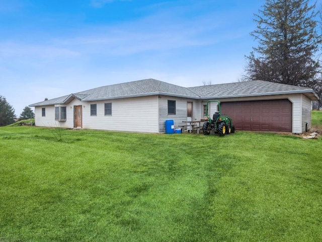 ranch-style home with roof with shingles, an attached garage, and a front yard