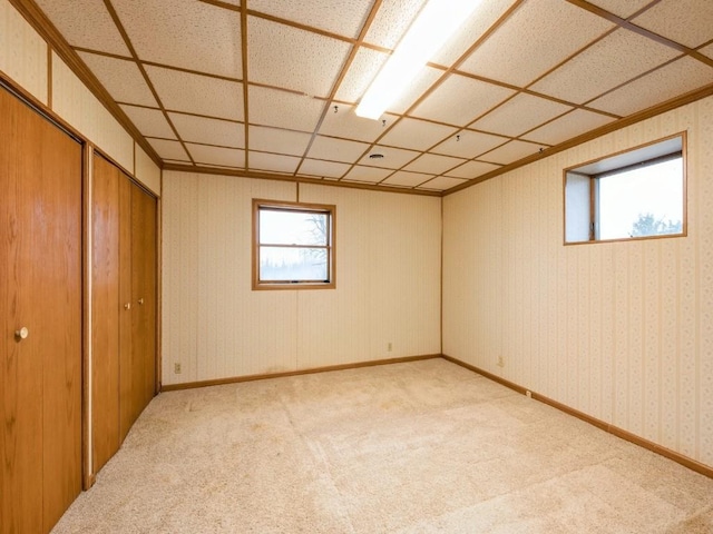 spare room with light carpet, wallpapered walls, and baseboards