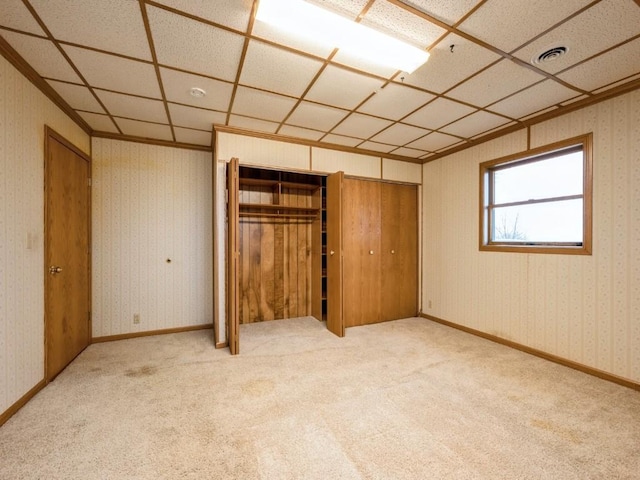 unfurnished bedroom with baseboards, carpet, visible vents, and wallpapered walls