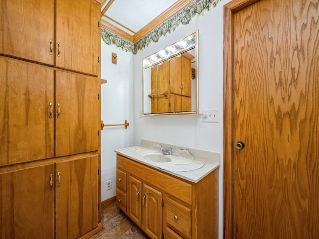 bathroom with crown molding and vanity