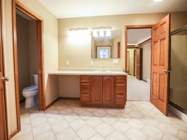 full bathroom featuring toilet, a shower stall, baseboards, and vanity