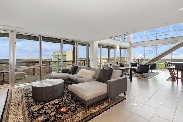 living area featuring a wall of windows, a view of city, track lighting, and tile patterned floors