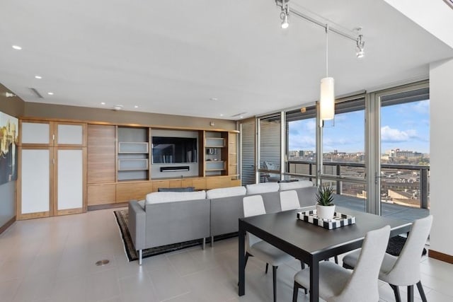 dining area with rail lighting, baseboards, a wall of windows, and recessed lighting