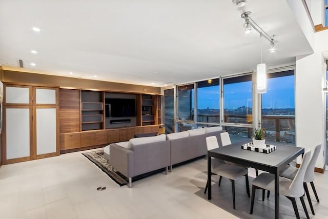 living area with expansive windows, recessed lighting, visible vents, and track lighting