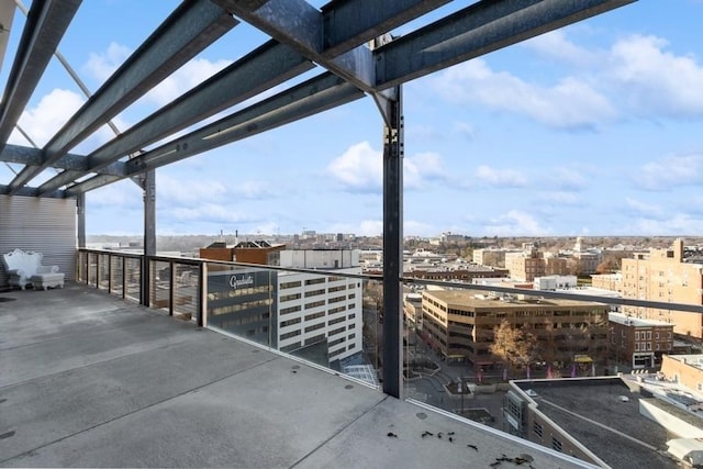 view of patio / terrace with a balcony, a pergola, and a city view