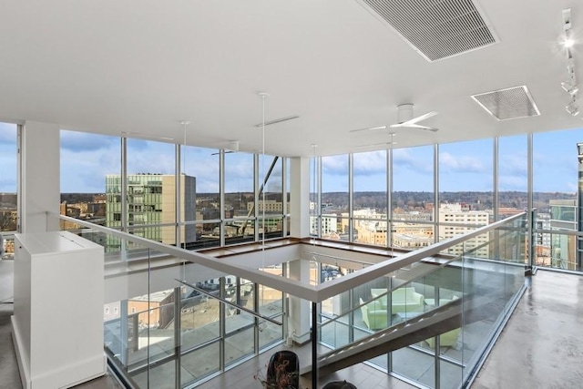 view of pool featuring ceiling fan and a city view