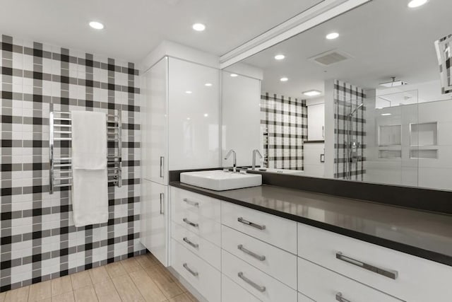 bathroom featuring a stall shower, recessed lighting, visible vents, and vanity