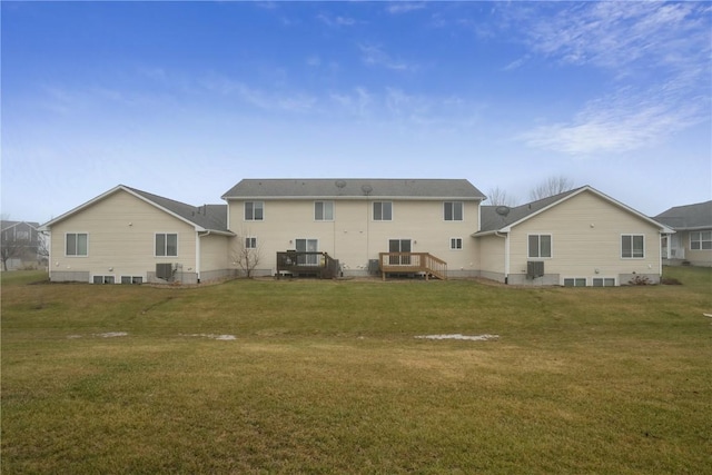 back of property featuring central AC and a lawn