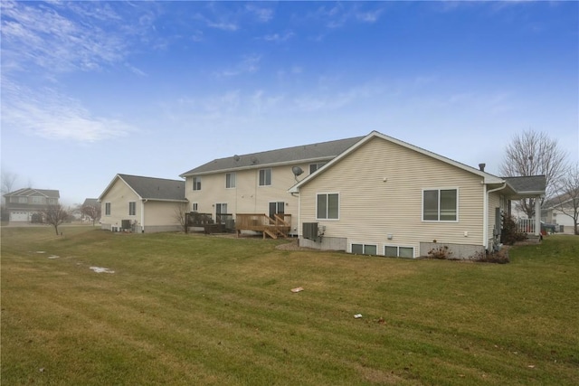 rear view of property with a yard and cooling unit