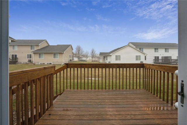 deck featuring a residential view and a yard