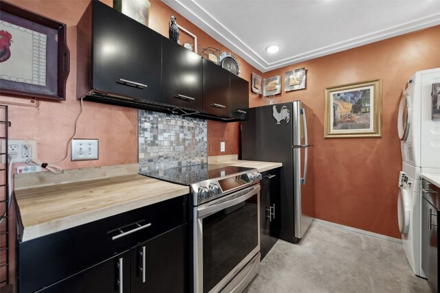 400 1st St SE Unit 203, Cedar Rapids, IA 52401 - kitchen with dark cabinets, stainless steel appliances, stacked washer / drying machine, and butcher block countertops