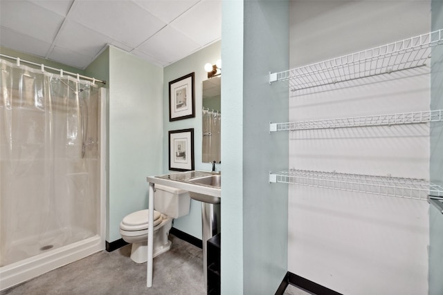 400 1st St SE Unit 203, Cedar Rapids, IA 52401 - full bathroom with a shower with shower curtain, concrete floors, and a drop ceiling