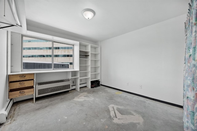 400 1st St SE Unit 203, Cedar Rapids, IA 52401 - unfurnished bedroom featuring unfinished concrete flooring and a baseboard heating unit