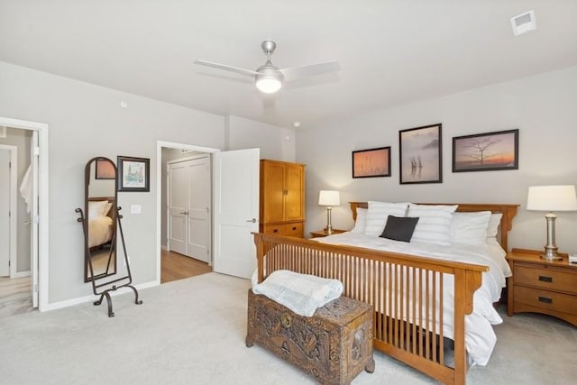 bedroom with ceiling fan, baseboards, visible vents, and light colored carpet