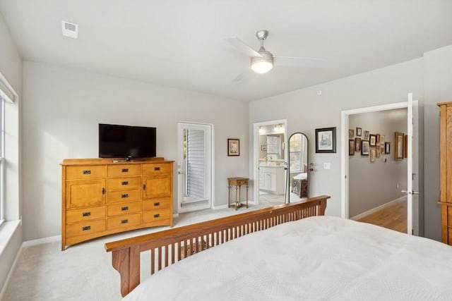 bedroom featuring baseboards, visible vents, connected bathroom, light colored carpet, and ceiling fan