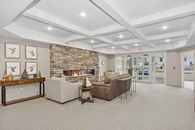 living room with a stone fireplace, recessed lighting, beam ceiling, and light colored carpet