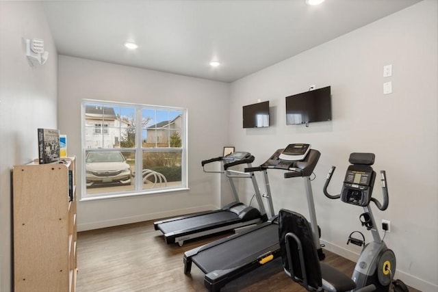 workout room featuring baseboards, wood finished floors, and recessed lighting