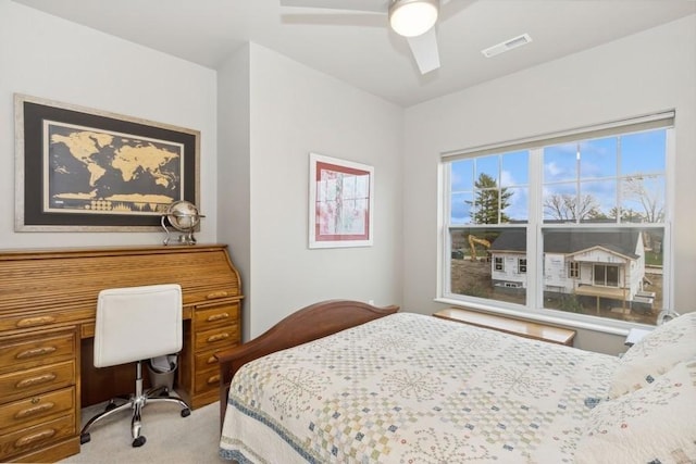 bedroom featuring a ceiling fan, light colored carpet, and visible vents