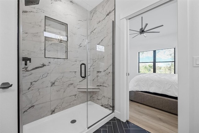 ensuite bathroom featuring connected bathroom, a marble finish shower, and wood finished floors