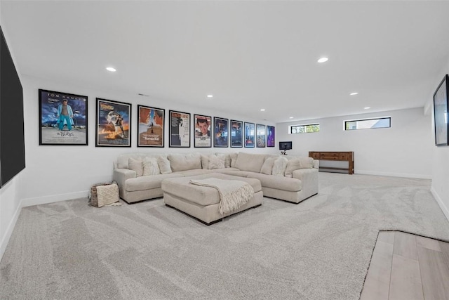 living area with carpet, baseboards, and recessed lighting