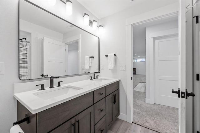 bathroom featuring a sink and double vanity