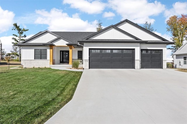 modern farmhouse featuring a front lawn, brick siding, driveway, and an attached garage