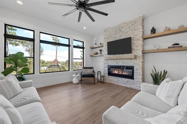 living room featuring a fireplace, recessed lighting, ceiling fan, wood finished floors, and baseboards