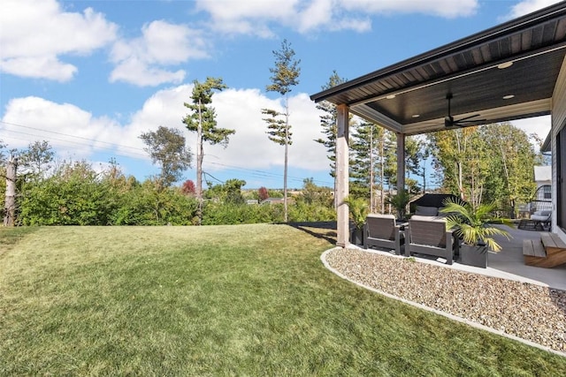 view of yard with ceiling fan, a patio, and an outdoor living space