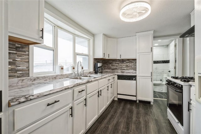 kitchen featuring white appliances, decorative backsplash, dark wood finished floors, light stone counters, and white cabinetry