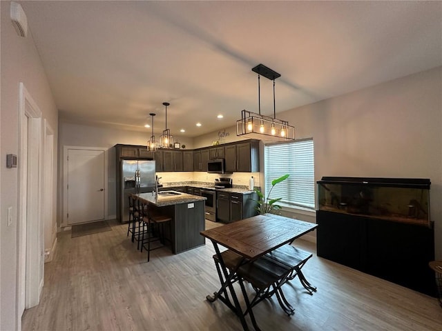 dining space with light wood finished floors and recessed lighting