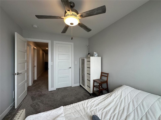 bedroom featuring a ceiling fan, dark carpet, and baseboards