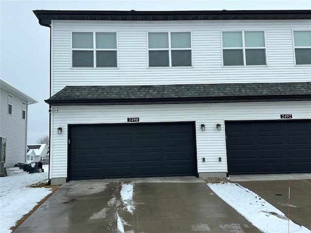 garage featuring concrete driveway