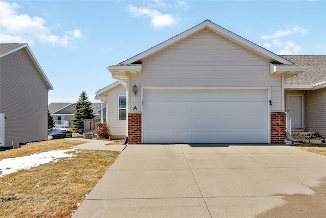 view of front of house featuring concrete driveway, brick siding, and an attached garage