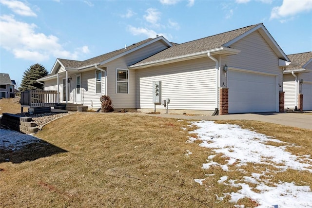 view of front of home featuring a garage, a lawn, and concrete driveway