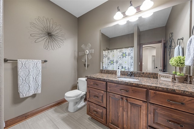 bathroom featuring vanity, toilet, and a shower with curtain