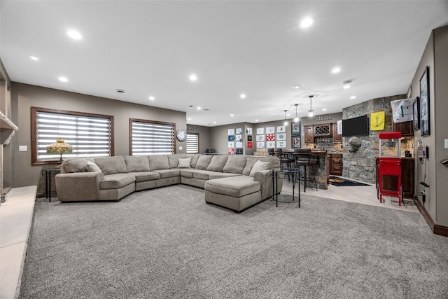 living room featuring carpet, bar, and recessed lighting