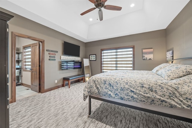 bedroom featuring ceiling fan, recessed lighting, light colored carpet, baseboards, and a tray ceiling