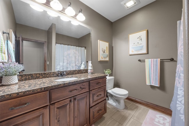 bathroom with visible vents, vanity, and toilet