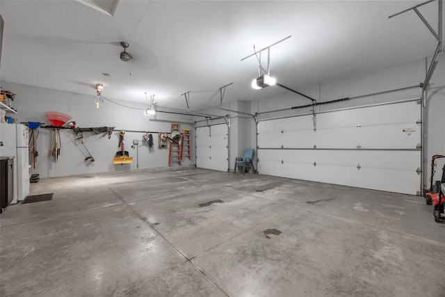 garage with freestanding refrigerator and a garage door opener