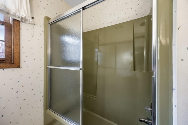 full bath featuring a washtub, an enclosed shower, and wallpapered walls