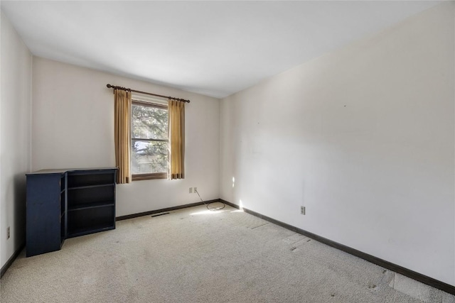 carpeted empty room with visible vents and baseboards